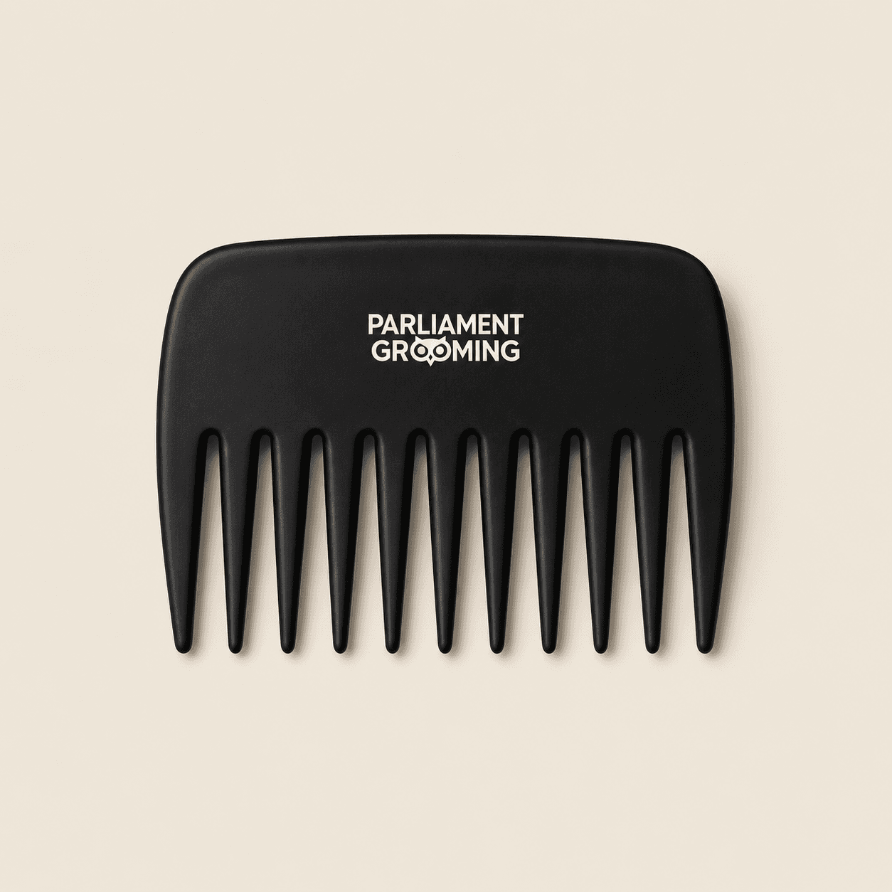 The Styling Comb, matte black with wide tapered teeth, on bone stock